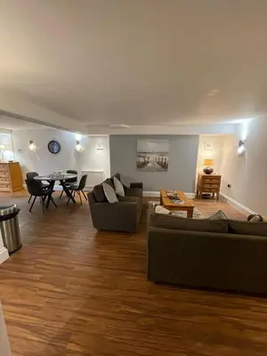 a living room with two couches and a table at No1 Apartment Mevagissey in Mevagissey