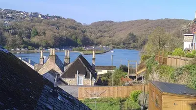 a view of a body of water with a river at Driftwood in Looe River view and parking in Looe