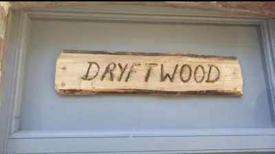 a sign that says dry wood hanging on a wall at Driftwood in Looe River view and parking in Looe