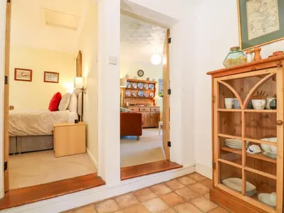 a room with a mirror and a bedroom at Jordan Cottage in Fowey
