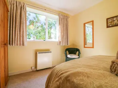a bedroom with a bed and a window at Jordan Cottage in Fowey