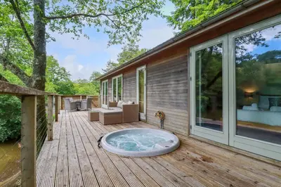 a deck with a hot tub on a house at 10 Water's Edge in Looe
