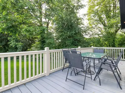 a patio with a table and chairs on a deck at 43 The Maples in St Austell