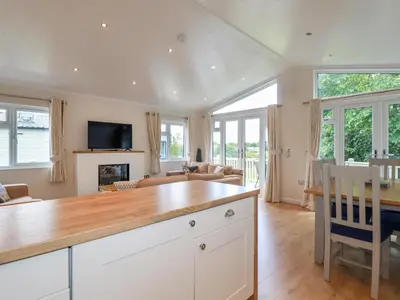 a kitchen and living room with a wooden counter top at 43 The Maples in St Austell