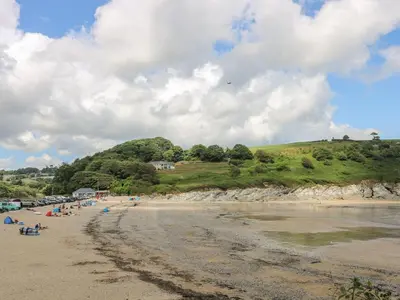 a group of people on a beach near the water at Jaspers Retreat, formerly known as Starfish Cottage in Falmouth