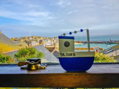 a blue and white cup sitting on a window sill at Admiral Cottage in St Ives