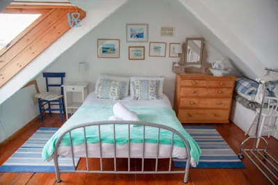 a bedroom with a bed in a attic at Admiral Cottage in St Ives