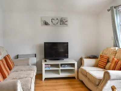 a living room with a tv and a couch at Boobys Bay - Uk47554 in St Merryn