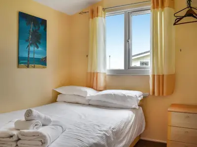 a bedroom with a bed with towels on it at Boobys Bay - Uk47554 in St Merryn