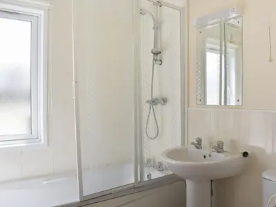 a white bathroom with a shower and a sink at Stepper Point - Uk47568 in St Merryn