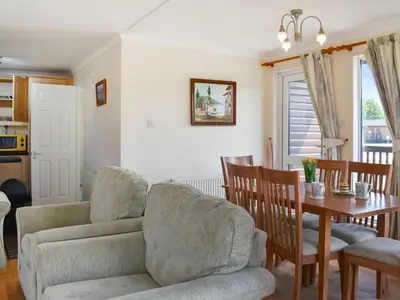 a kitchen and dining room with a table and chairs at Stepper Point - Uk47568 in St Merryn