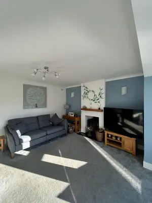 a living room with a couch and a flat screen tv at Newquay Fistral Holiday home with hot tub in Newquay