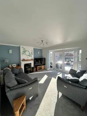 a living room with two couches and a tv at Newquay Fistral Holiday home with hot tub in Newquay
