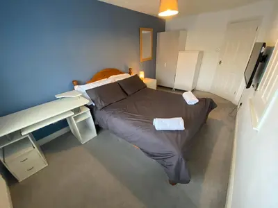 a bedroom with a large bed in a room at Newquay Fistral Holiday home with hot tub in Newquay