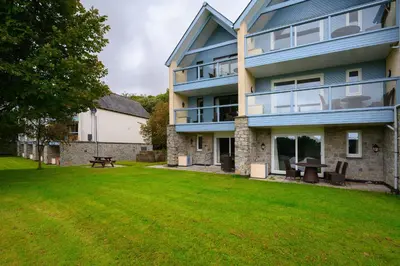 a large house with a lawn in front of it at Clowance, Golf View 80b in Praze an Beeble