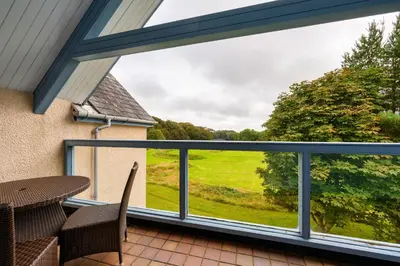 a view from the balcony of a house with a window at Clowance, Golf View 80b in Praze an Beeble