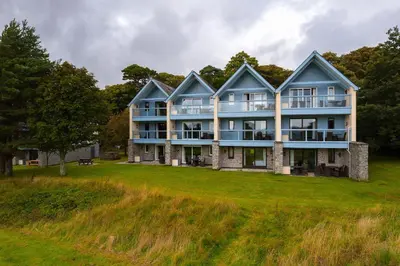a large house on a grassy field at Clowance, Golf View 80b in Praze an Beeble