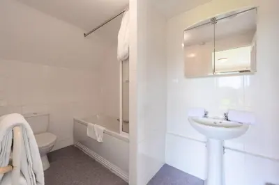 a white bathroom with a sink and a toilet at Clowance, Golf View 80b in Praze an Beeble
