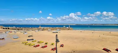 a beach with a bunch of boats in the sand at Premier 2 - Stunning Suite with Breathtaking Seaside Views in St Ives