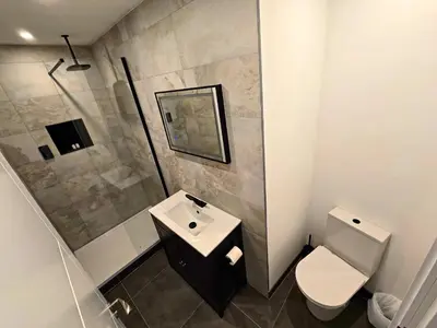 a bathroom with a sink and a toilet at Premier 2 - Stunning Suite with Breathtaking Seaside Views in St Ives