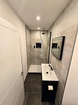 a bathroom with a sink and a shower at Premier 2 - Stunning Suite with Breathtaking Seaside Views in St Ives