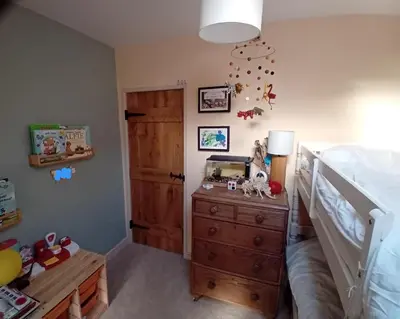 a bedroom with a bed and a wooden dresser and a bed at Tranquil Cornish Heritage Retreat in Falmouth