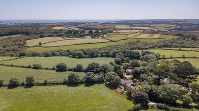an aerial view of a house in a field at Tranquil Cornish Heritage Retreat in Falmouth