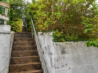 a set of stairs leading up a concrete wall at Trethvor in Perranporth