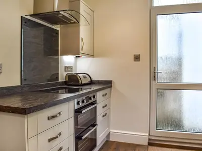 a kitchen with a sink and a stove at Trethvor in Perranporth