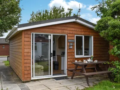 a small shed with a table in front of it at Gunner Head - Uk47557 in St Merryn