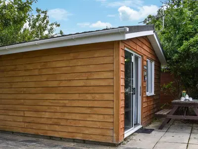 a small building with a door and a patio at Gunner Head - Uk47557 in St Merryn