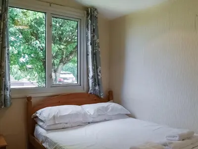 a bedroom with a bed and a window at Gunner Head - Uk47557 in St Merryn