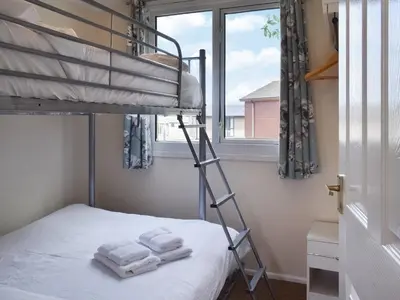 a bunk bed in a room with a window at Gunner Head - Uk47557 in St Merryn