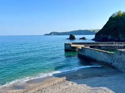 a view of the ocean with a beach and rocks at Harber Rise House in Carlyon Bay