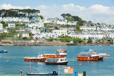 a group of boats in a body of water with houses at Landing View Fowey Penthouse in Fowey