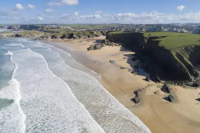 an aerial view of a beach with waves at Sea Breeze, Newquay in Newquay