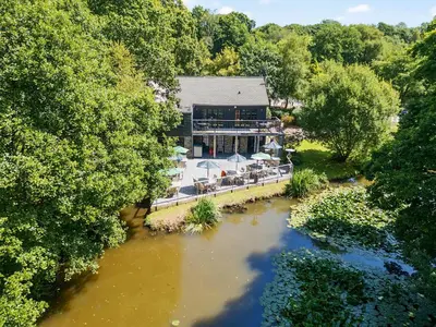 an aerial view of a building next to a river at 3 Lake View in Looe