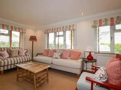 a living room with a couch and a table at 6 Trelawney Court in Wadebridge