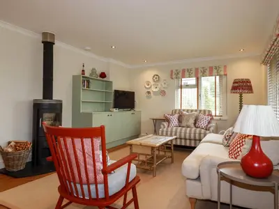 a living room with a couch and a table at 6 Trelawney Court in Wadebridge
