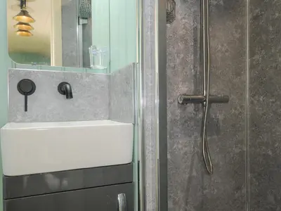 a bathroom with a sink and a shower at Bracken in Bude
