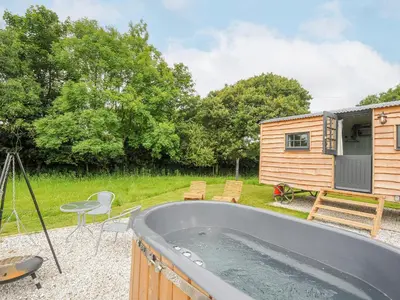 a tiny house with a tub in a yard at Bracken in Bude