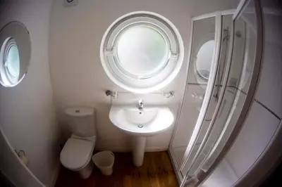 a bathroom with a sink and a toilet and a window at Birdsong in Carbis Bay