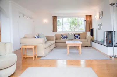a living room with a couch and a table at Birdsong in Carbis Bay