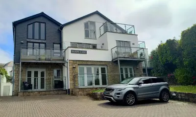 a car parked in front of a house at 5 Sandy Lane Apartments, Carbis Bay in Carbis Bay
