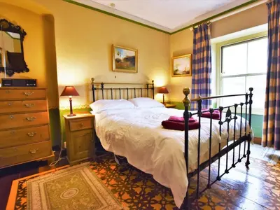 a bedroom with a bed and a dresser at 3 Bed in Polruan oc-pc032 in Fowey