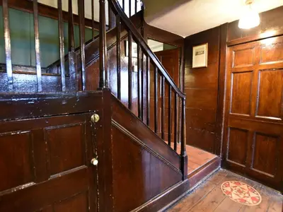 a wooden staircase with a wooden door in a room at 3 Bed in Polruan oc-pc032 in Fowey