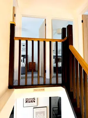 a staircase in a house with a view of a room at 13 WinterSlow Cottage in St Ives