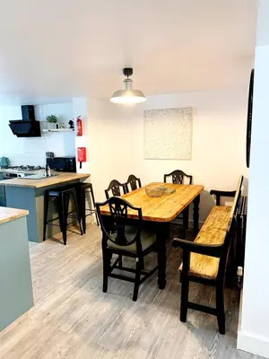 a kitchen and dining room with a wooden table and chairs at 13 WinterSlow Cottage in St Ives