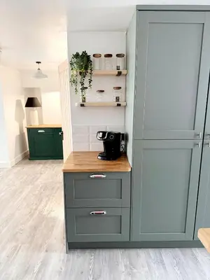 a kitchen with green cabinets and a counter at 13 WinterSlow Cottage in St Ives