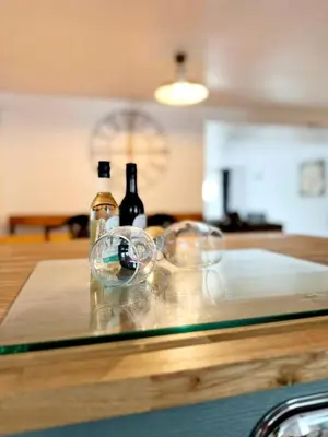 two bottles of wine sitting on a wooden table at 13 WinterSlow Cottage in St Ives